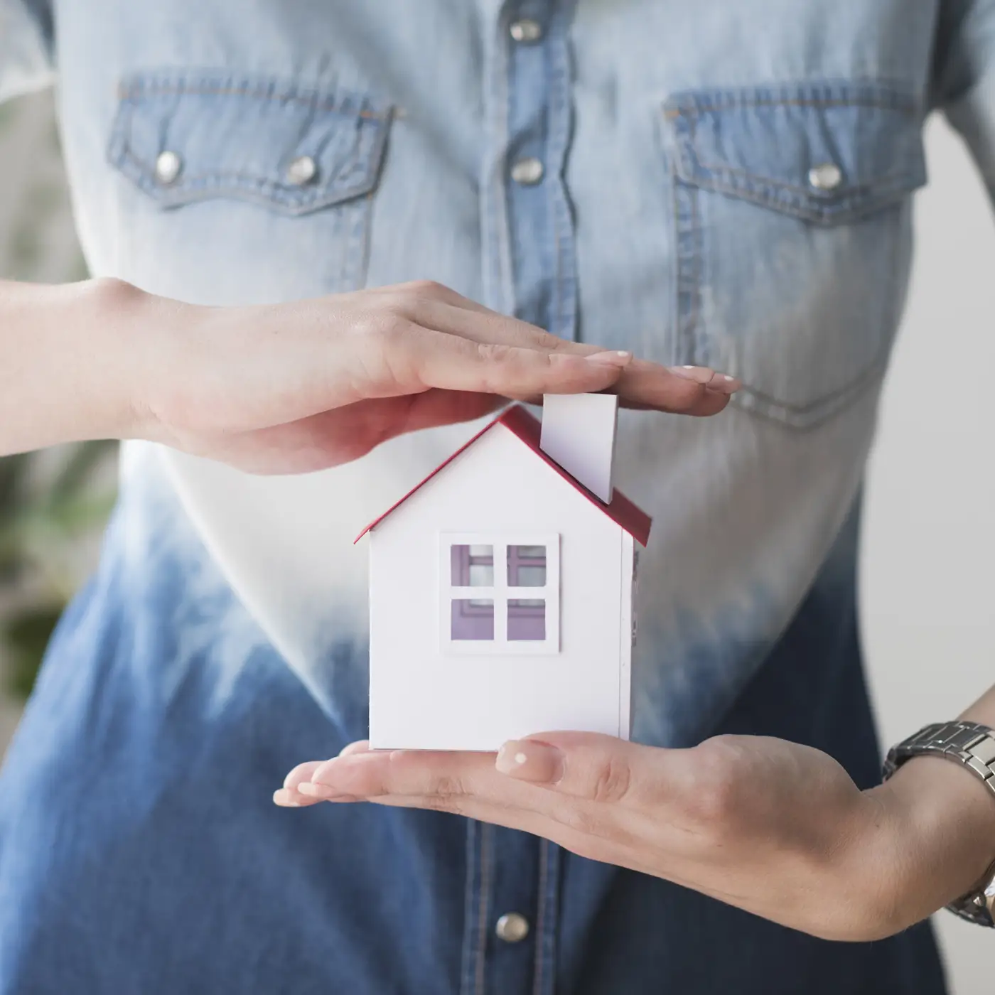 Woman holding model sized home